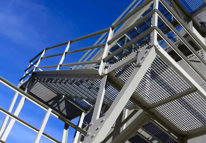 Metal scaffolding structure against a clear blue sky.