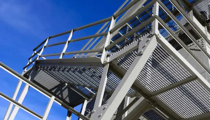 Metal scaffolding structure against a clear blue sky.