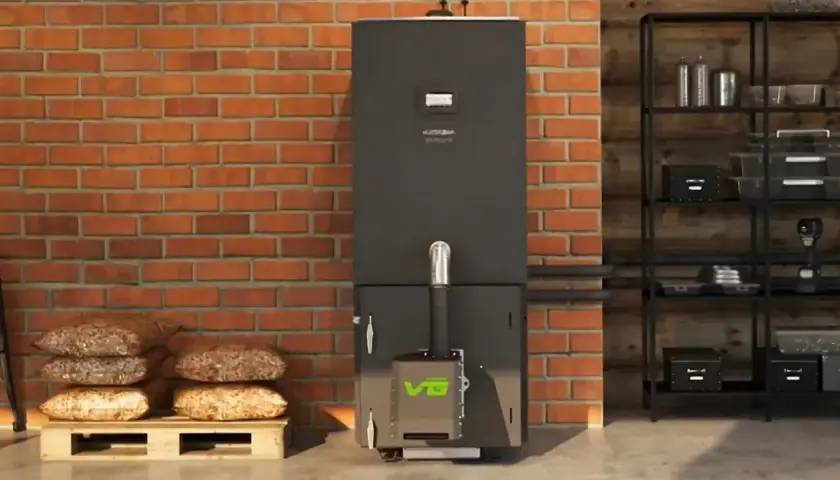 Nowoczesny piec na pellet z zielonym logo, obok palety z workami pelletu. Dofinansowanie do pieca na pellet może być Twoje!